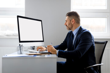 Poster - Businessman looking at blank computer monitor sitting in office, watching webinar, having online video call, mockup