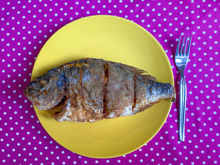 Wall Mural - Bream on a plate and a fork on the side