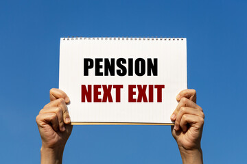 Pension next exit text on notebook paper held by 2 hands with isolated blue sky background. This message can be used as business concept about pension.