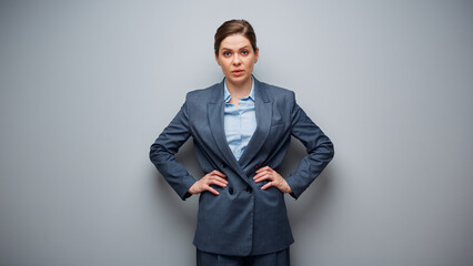 Wall Mural - Portrait of serious woman in business modern suit on gray background.