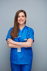 Wall Mural - Smiling doctor woman or nurse on gray back.