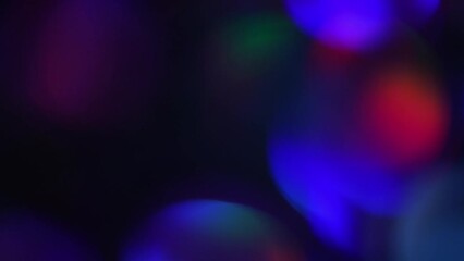 Canvas Print - Neon Bokeh Motion Background. Blurred night lights glow. Abstract Movement of defocused circles of blue, purple, red and green. Glowing vibrant bokeh lights in a 4K moving background.