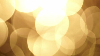 Wall Mural - Abstract Glow Bokeh Background In Golden Sepia Tones. Abstract shimmering movement of large defocused circles. Circles Bokeh Lights smooth motion. Light Leaks 4K moving background.