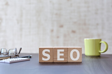 Leinwandbilder - There is wood cube with the word SEO. It is an acronym for Search Engine Optimization an eye-catching image.