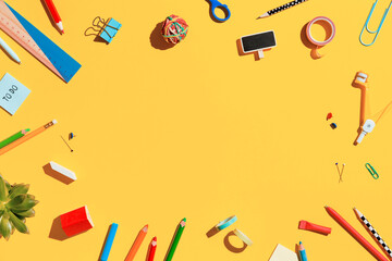 Wall Mural - School supplies collection on pastel yellow background. Back to school flat lay.	
