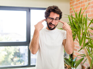 Wall Mural - young adult crazy man with expressive pose at a modern house interior