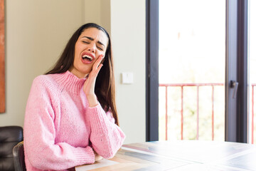 Wall Mural - pretty caucasian woman feeling shocked and astonished holding face to hand in disbelief with mouth wide open