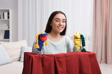 Canvas Print - Happy woman performing puppet show at home