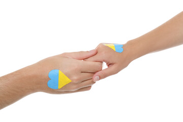 Wall Mural - Man and woman with painted Ukrainian flags on their hands against white background, closeup