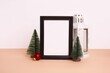 Closeup shot of a Christmas decorative composition with a frame and Christmas trees