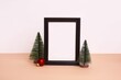 Closeup shot of a Christmas decorative composition with a frame and Christmas trees