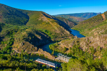 Wall Mural - Panorama of Navea river passing Pontenovo hydro power plant in Spain