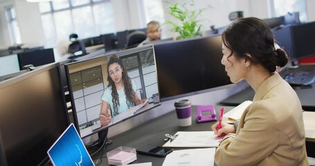 Canvas Print - Diverse business people having video call and using laptop with digital chat on screen in office