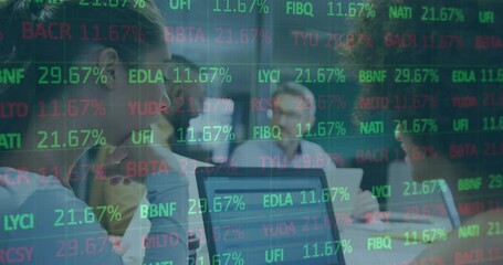 Wall Mural - Animation of stock market data processing over two diverse women discussing over a laptop at office