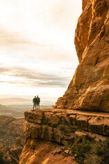 Wall Mural - Young couple side by side are on top of Cathedral Rock in Sedona pose for vertical photo.