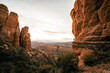 Wide angle view of man watching sunset in Sedona Arizona from Cathedral Rock Viewpoint.
