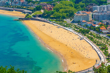 Wall Mural - People are enjoying a sunny day at La Concha beach at San Sebastian, Spain