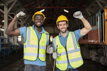 Two male engineer workers raise hands together in industry factory, feeling happy and smiling, completed finished job and teamwork successful concept. Group of male technician worker successful work