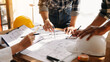 © Nuttapong punna - Confident team of architect working together in a office.Then discussing about new startup project on desk.in office..