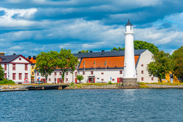 Wall Mural - Lighthouse at traditional port buildings in Karlshamn, Sweden.