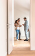 © lordn - Young married couple talking with a real-estate agent visiting an apartment for sale or for rent. Future parents buying an apartment. Real estate concept. A new beginning