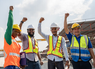 Wall Mural - Hand cheering African American and Asia team engineer at outdoor site work