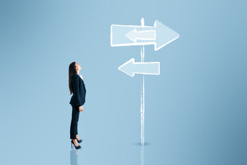 Canvas Print - Young european business woman thinking which path to choose on blue background with sign sketch. Different direction concept.