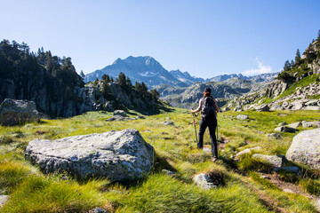 young hiker girl summit to ratera peak in aiguestortes and sant maurici national park, spain