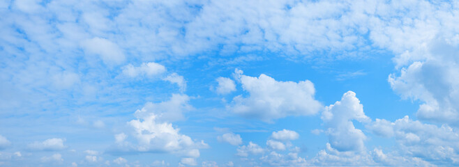 Wall Mural - cloudscape panorama blue sky with fluffy fleecy clouds and cumulus in the middle