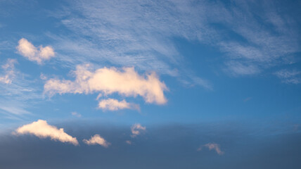 Wall Mural - dark blue sky in the evening with lighted cumulus clouds copy space