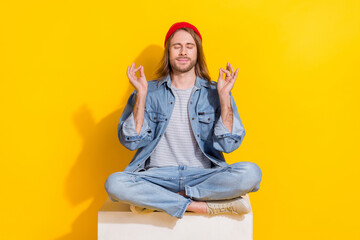 Poster - Photo of cool dreamy guy dressed jeans shirt smiling practicing yoga isolated yellow color background