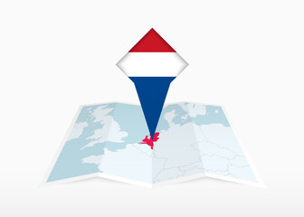 Wall Mural - Netherlands is depicted on a folded paper map and pinned location marker with flag of Netherlands.