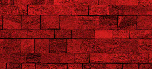 Wall Mural - wide old stone wall texture with red lighting. panoramic stone block wall background with red light 