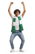 Happy african american young man cheering with a green and white scarf