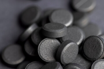 Open and unpacked tablets of black color close-up