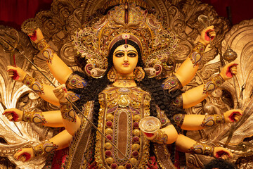 Idol of Goddess Devi Durga at a decorated puja pandal in Kolkata, West Bengal, India. Durga Puja is a famous and major religious festival of Hinduism that is celebrated throughout the world.