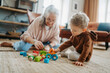 © Halfpoint - Grandmother playing with her little grandson,building a block set.