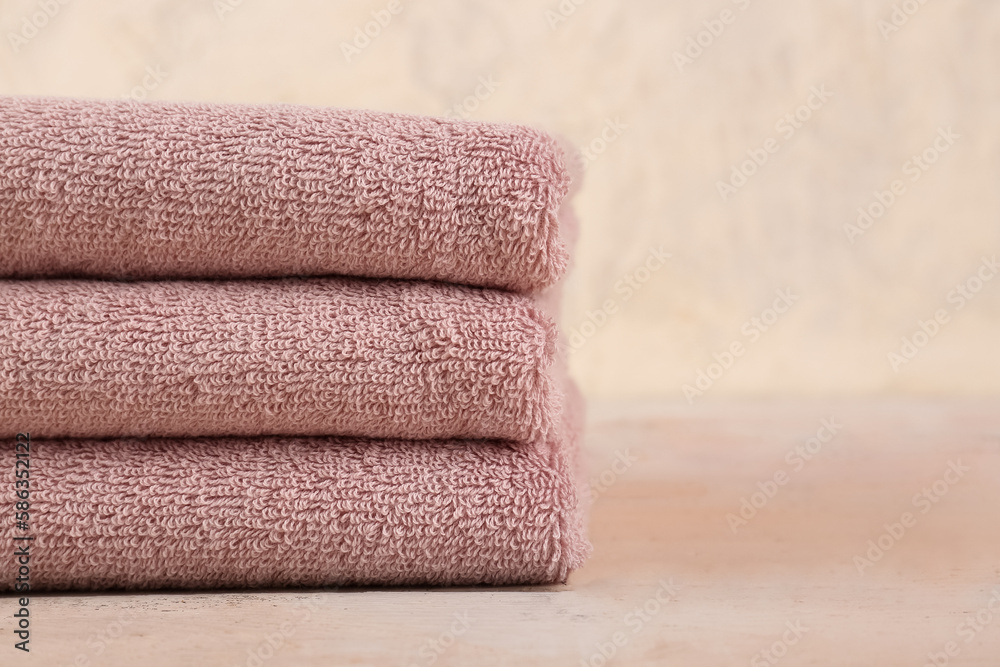 Stack of folded soft towels on wooden table