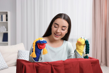 Canvas Print - Happy woman performing puppet show at home