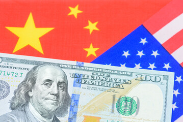 Wall Mural - Trade tension, trade war, commercial conflict between US and China, economic concept : US dollar bill and a Chinese flag. Depicting a significant deterioration in the relationship between US and China