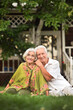 © aletia2011 - Elderly couple sits on the grass in summer