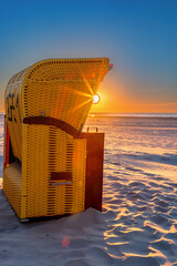 Wall Mural - Beach chair at sunset on the beach on Juist, East Frisian Islands, Germany.