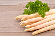 White asparagus and  bunch parsley on wooden table. Fresh vegetables.