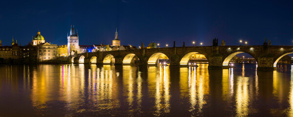 Wall Mural - Prague nightscape with the city skyline, landmark buildings, old town towers, and Charles Bridge over the Vltava River Czech Republic