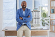 © Yusrah Abbas/peopleimages.com - Happy black man, arms crossed and mature portrait in corporate office, company about us or profile picture of CEO introduction. Smile, confident and management person with financial success mindset