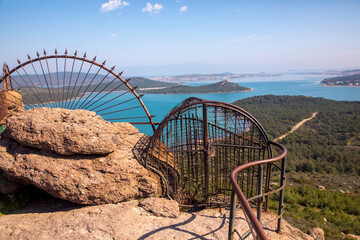 Poster - Devil's Table know as Seytan Sofrasi , Ayvalik. Place devil's footprint, It's believed, if you tie a ribbon with wish to iron fence, it will come true