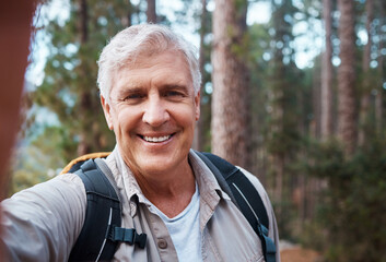 Wall Mural - Selfie portrait, forest and senior man hiking, fitness and outdoor health with happy blog update for social media. Nature, travel and trekking of mature person in woods with profile picture post
