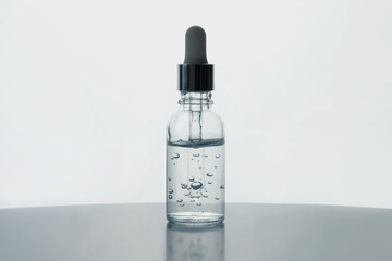 Glass dropper bottle with oxygen cosmetic gel on backlight