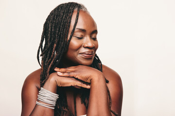 Beautiful woman with dreadlocks smiling with her eyes closed