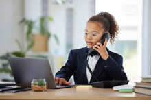 Kids, Telephone And A Girl Playing In An Office As A Fantasy Businesswoman At Work On A Laptop. Children, Phone Call And A Female Child Working At A Desk While Using Her Imagination To Pretend